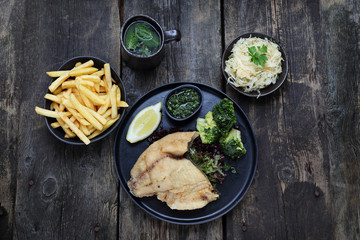 Fish and chips and salad. Dinner meal