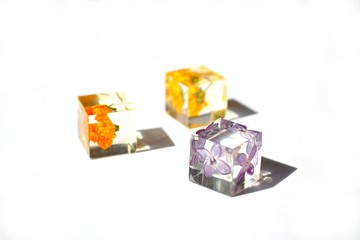Dried flowers in resin cube. Jewelry.