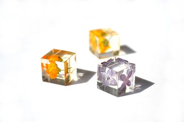 Dried flowers in resin cube. Jewelry.