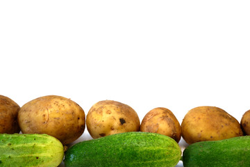 Potatoes and cucumbers on white background close up. Free space for your text.