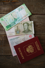 A Russian passport with a Chinese visa and money is one yuan. Visa stamp, passport. Vacation and travel concept. Top view. Flat lay.