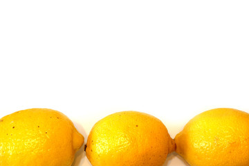 Three juicy fresh lemons on white background with free space for custom text close up view