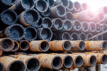 Drill pipe of  oil drilling platforms. Stack of oil well casing bundles at the pin end of casing....