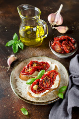 Bruschetta with olive oil, sundried tomatoes, cottage cheese and fresh basil