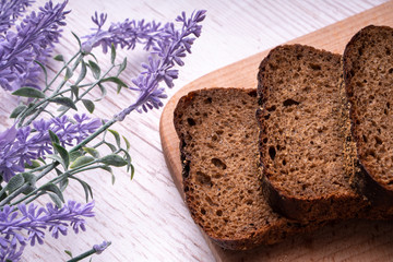 Homemade rye bread, rustic style for breakfast, lavender flowers.
