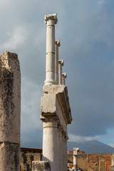 Antique  marble columns on a blue sky background. The ancient ruins of Pompeii