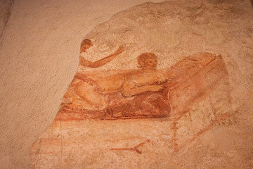 Fresco with sexy scenes on the walls in the Casa delle Lupanare of Pompeii. Italy.