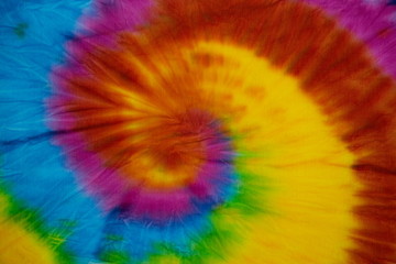 Tie Dye spiral rainbow swirl abstract texture and background , reggae style .