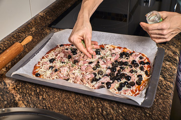 woman hands working on a pizza dough