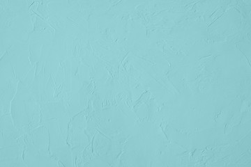 Pale blue colored low contrast Concrete textured background with roughness and irregularities to...