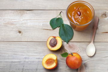 Fruits of nectarines or apricots with jam on a table made of dark wood, bright natural colors, high...