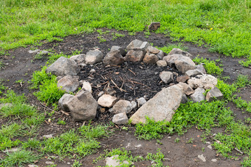 Campfire fireplace fire hole pit made of stones in nature