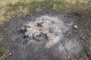 Campfire fireplace fire hole pit made of stones in nature