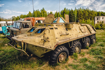 Old soviet russian rusty radioactive equipment stands in dump over fence