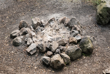 Campfire fireplace fire hole pit made of stones in nature