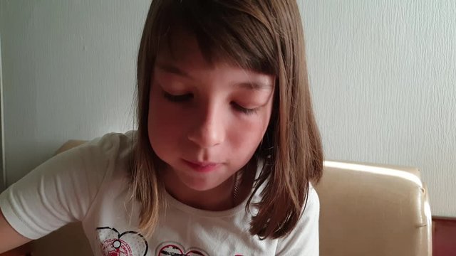 girl eating spaghetti with tomato sauce