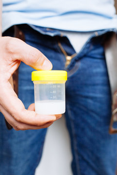 Man Holding in Hands Container With Sperm