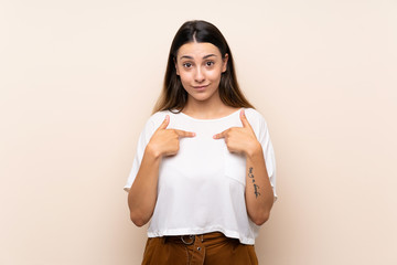 Young brunette woman over isolated background with surprise facial expression