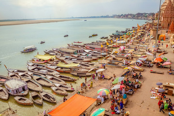 Aerial view of Ganges river ghat at Varanasi, India with view of wooden boats lined up along the...