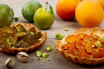 plum and apricot pies on wooden background © Fox_Dsign
