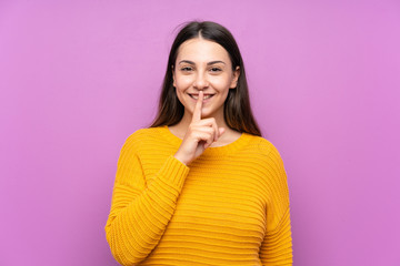Young woman over isolated purple background doing silence gesture