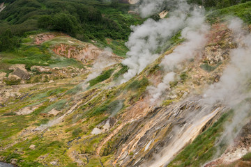 Valley of Geysers in Kronotsky Nature Reserve. Geyser field on Kamchatka Peninsula, Russia. Slope...