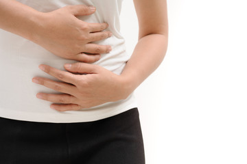 Young woman suffering from abdominal pain feeling stomachache, symptom of pms on white background