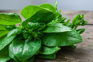 fresh green spinach on table soft focus