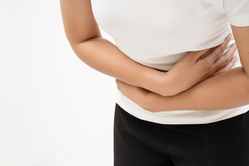 Young woman suffering from abdominal pain feeling stomachache, symptom of pms on white background