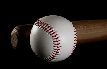 Baseball and wooden bat isolated on black background