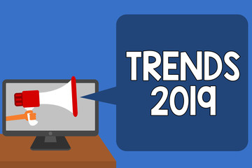 Handwriting text Trends 2019. Concept meaning Upcoming year prevailing tendency Widely Discussed Online Man holding Megaphone loudspeaker computer screen talking speech bubble