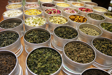 Pots of differents tea leaves on a table