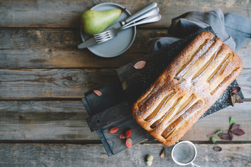 Homemade pear cake on wooden table. Cozy autumn pastries