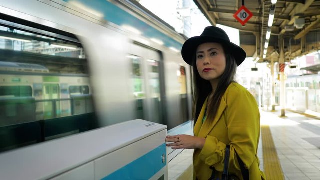 Japanese woman waiting for a train in Tokyo Japan