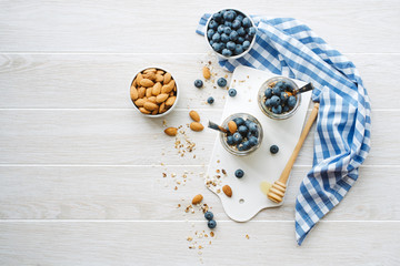 Healthy breakfast in glass jar with yogurt, muesli and blueberries. Healthy food. View from above