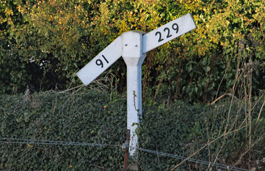 A level or gradient sign by the side of the railway track of the West Somerset heritage railway.