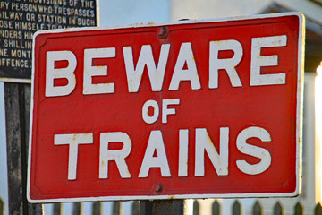 Fototapeta premium WEST SOMERSET RAILWAY, BLUE ANCHOR, SOMERSET - NOVEMBER 11TH 2012: A warning sign at Blue Anchor station saying Beware of trains