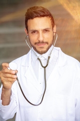 handsome doctor in white coat with stethoscope