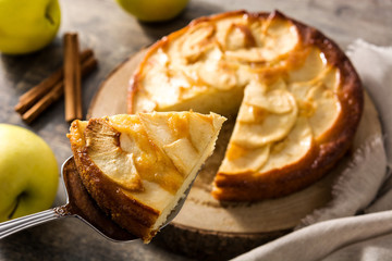 Homemade slice apple pie on wooden table.