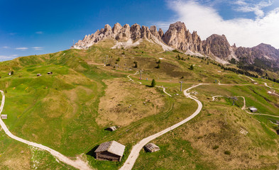Aerial top view from drone to wonderful alpine landscape and meadows at Pass Gardena with majestic Sella mountain group in Dolomiti. Alps, South Tirol, Dolomites mountains, passo di Val Gardena, Italy