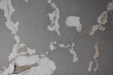 Detail of abandoned, run-down house wall. Ruined wall. background of an old dirty wall with gray paint