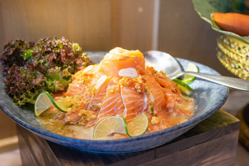 Thai spicy salmon sashimi salad. Food background.