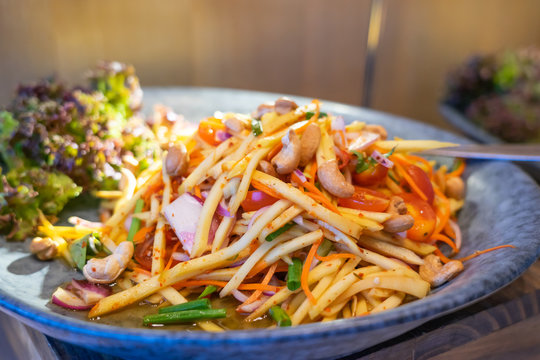 Thai spicy seafood mango salad. Food background.