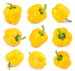 Set of ripe yellow bell peppers on white background
