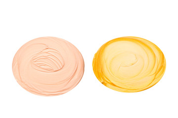 Liquid body and face highlighter isolated on white background. Golden and beige color.  Body cream.