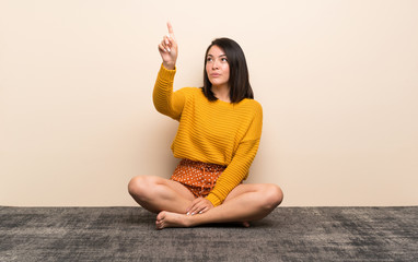 Young Mexican woman touching on transparent screen