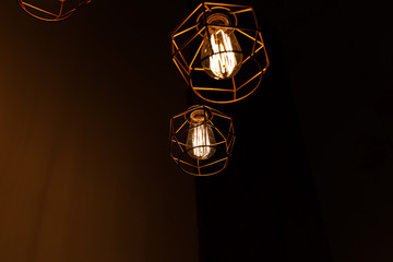 Vintage pendant light bulbs Edison on a dark background. Сoncept of creativity. Old vintage light...