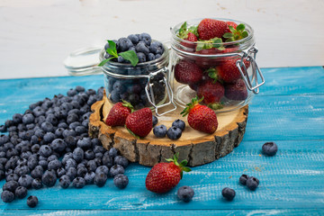 Berries from the garden. Garden berries. variety of berries on a blue background. copyspace