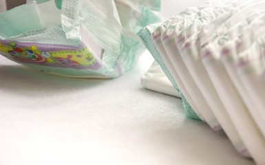 close-up view of a group of folded white diapers ready to be used. Health care of the newborn