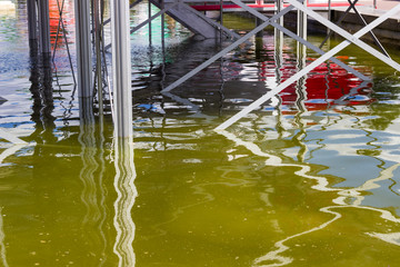 Multi-colored reflections of metallic structures in water